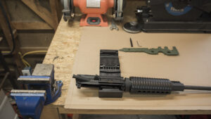 The upper receiver of an AR-15 placed into a vice