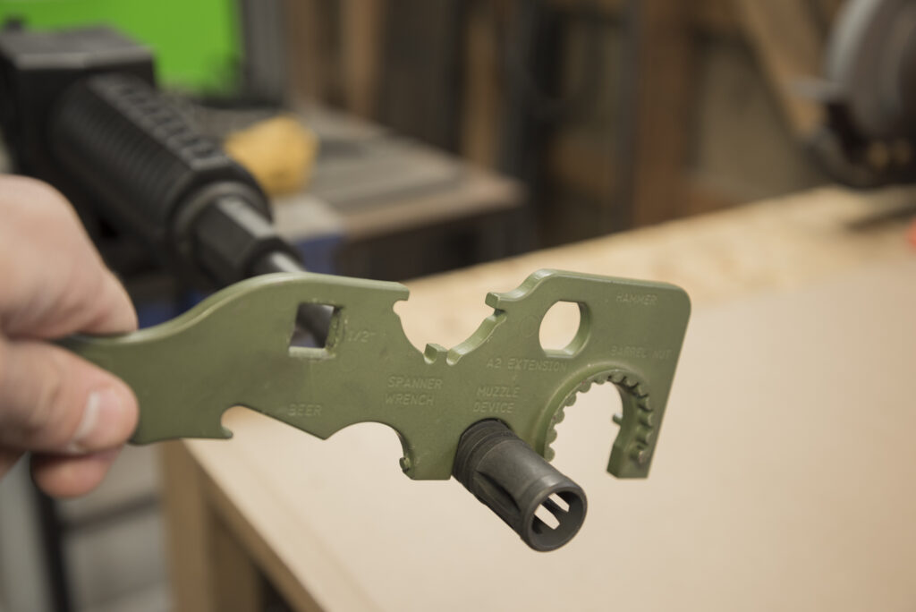 Installing a flash suppressor on the AR-15 barrel using an armorer's tool