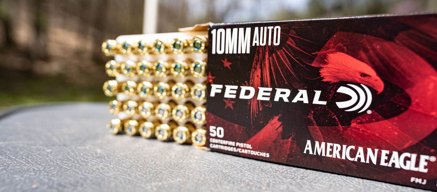 Box of Federal American Eagle 10mm ammo on a shooting bench