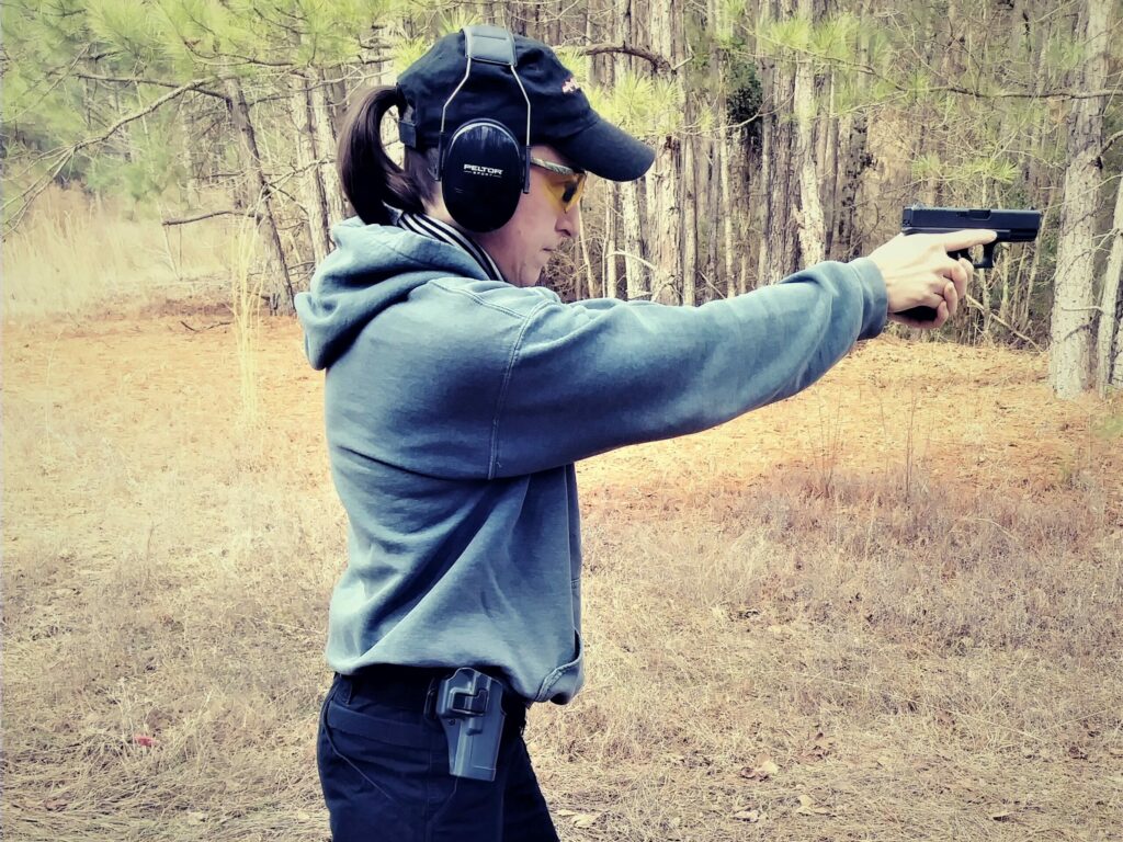 The author shooting her Glock 19 at the shooting range