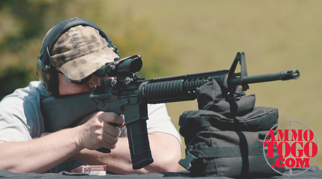 photo of a man shooting an AR-15 rifle