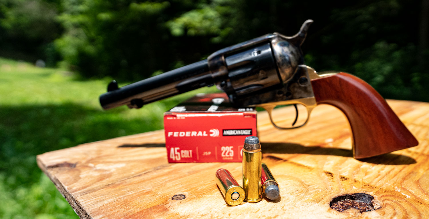 45 long colt revolver with ammunition at a shooting range