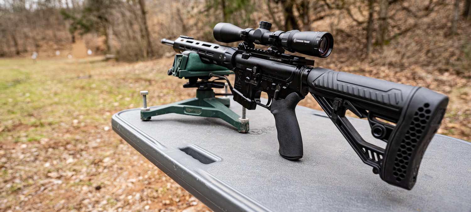 A 6.5 Grendel rifle equipped with an MOA optic on a benchers