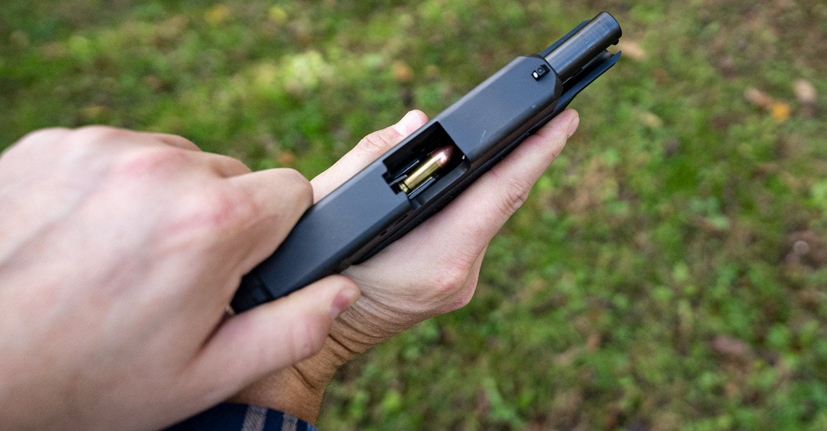 An ammo cartridge loaded into the chamber of a pistol