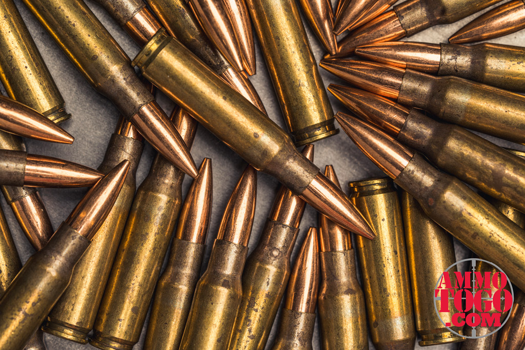 308 rifle ammo a photo of 308 rifle ammo on top of a steel plate