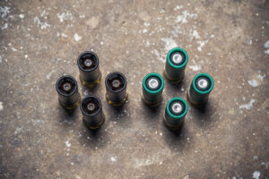 photo of sabot slugs next to lead slugs on a concrete floor