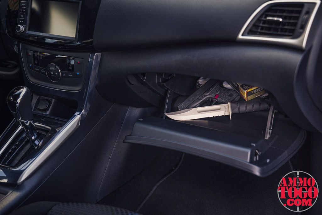 A photo of a 9mm glock 43 and a kabar knife in a glove compartment showing gun laws vs knife laws