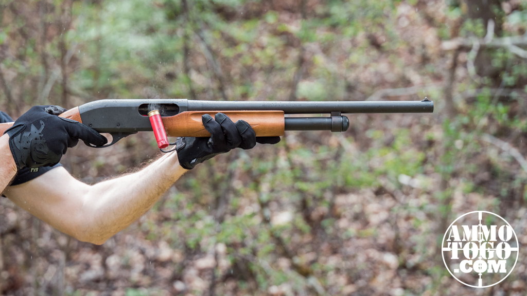 The author firing a 12 gauge shotgun at a shooting range