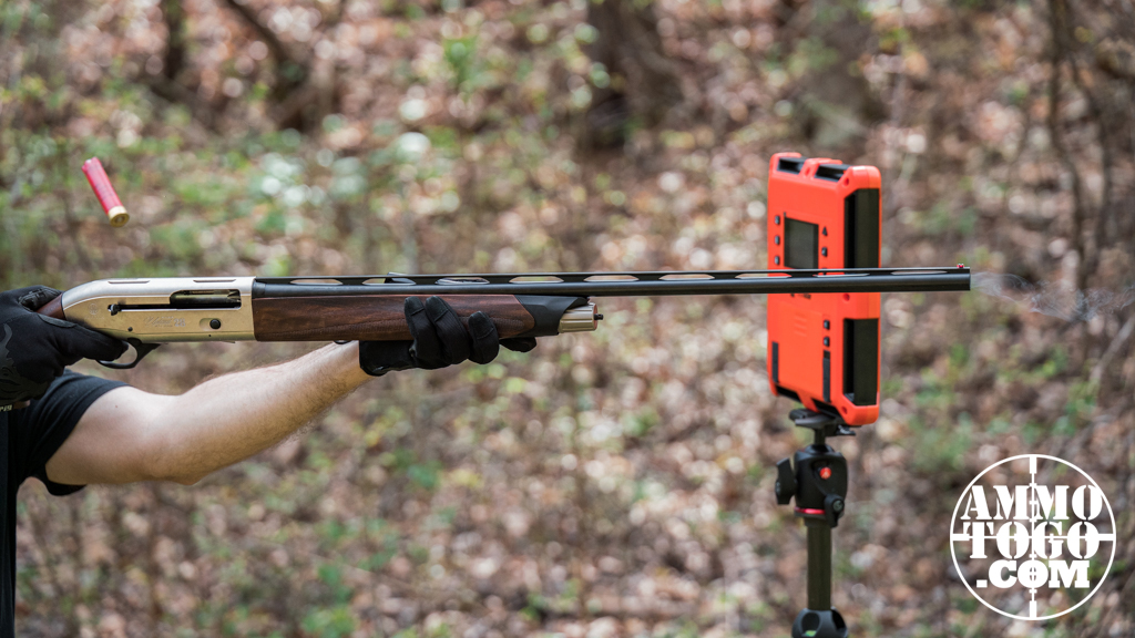 The author firing a Beretta 28 gauge shotgun at an outdoor shooting range