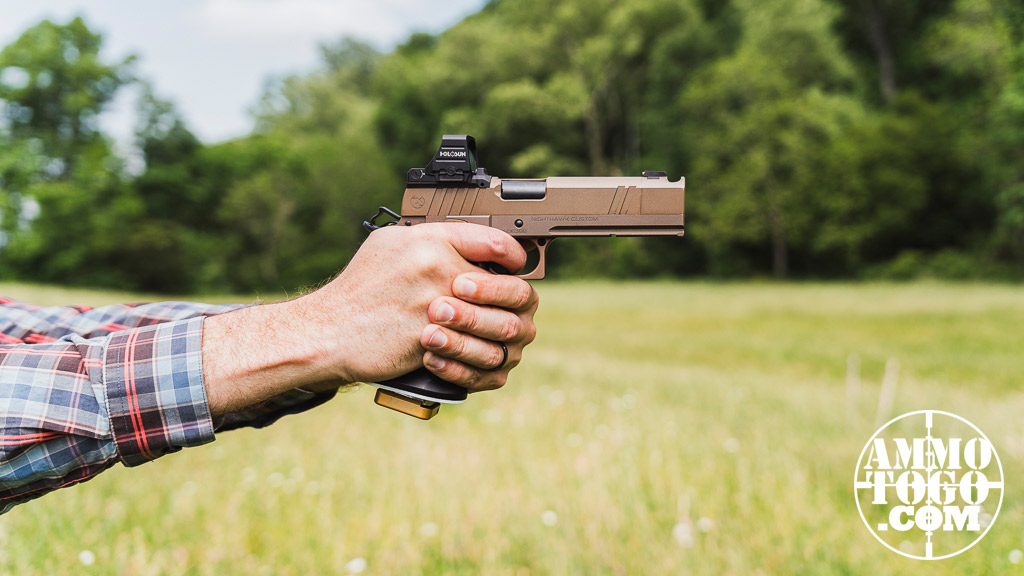 The author firing a 2011 pistol at a shooting range