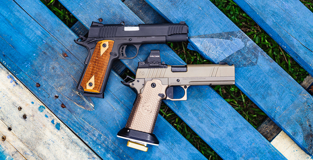 2011 vs 1911 pistols side by side on a shooting bench at the range