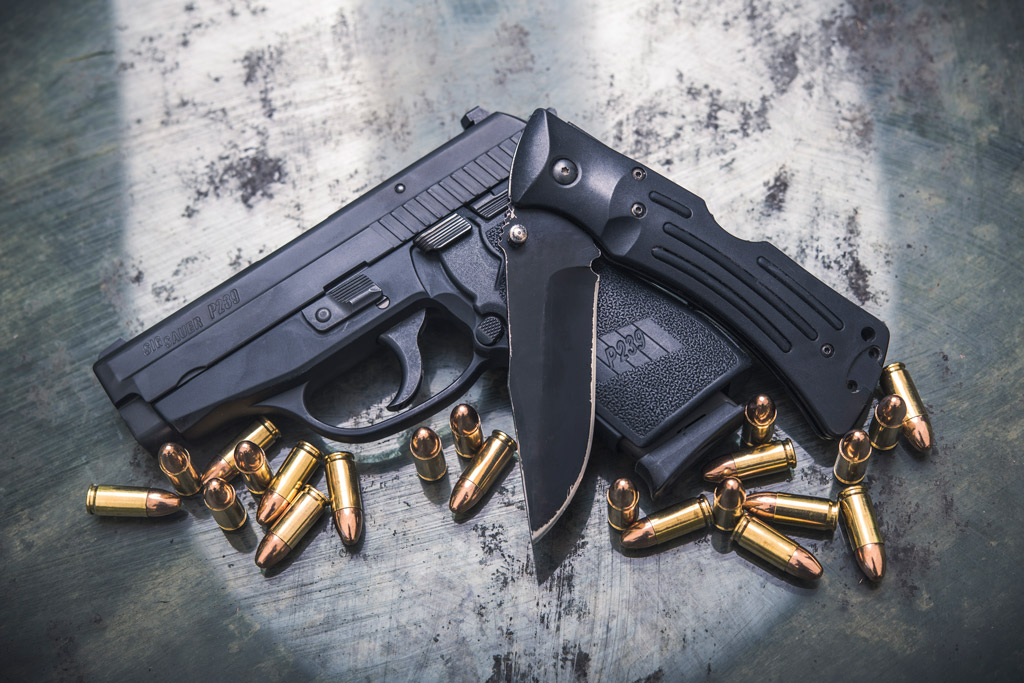 a photo of a sig 9mm handgun and a folding knife gun laws vs knife laws