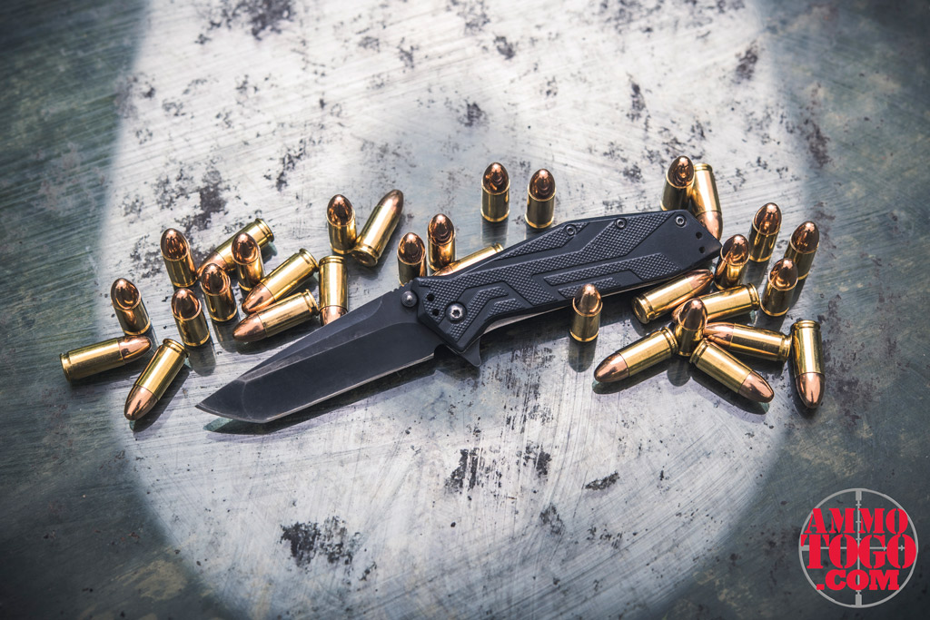 A photo of a assisted opening knife and 9mm ammo showing gun laws vs knife laws