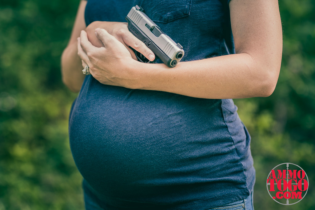 woman shooting while pregnant outdoors with a glock 48 pistol a photo of a woman shooting while pregnant outdoors with a glock 48 pistol