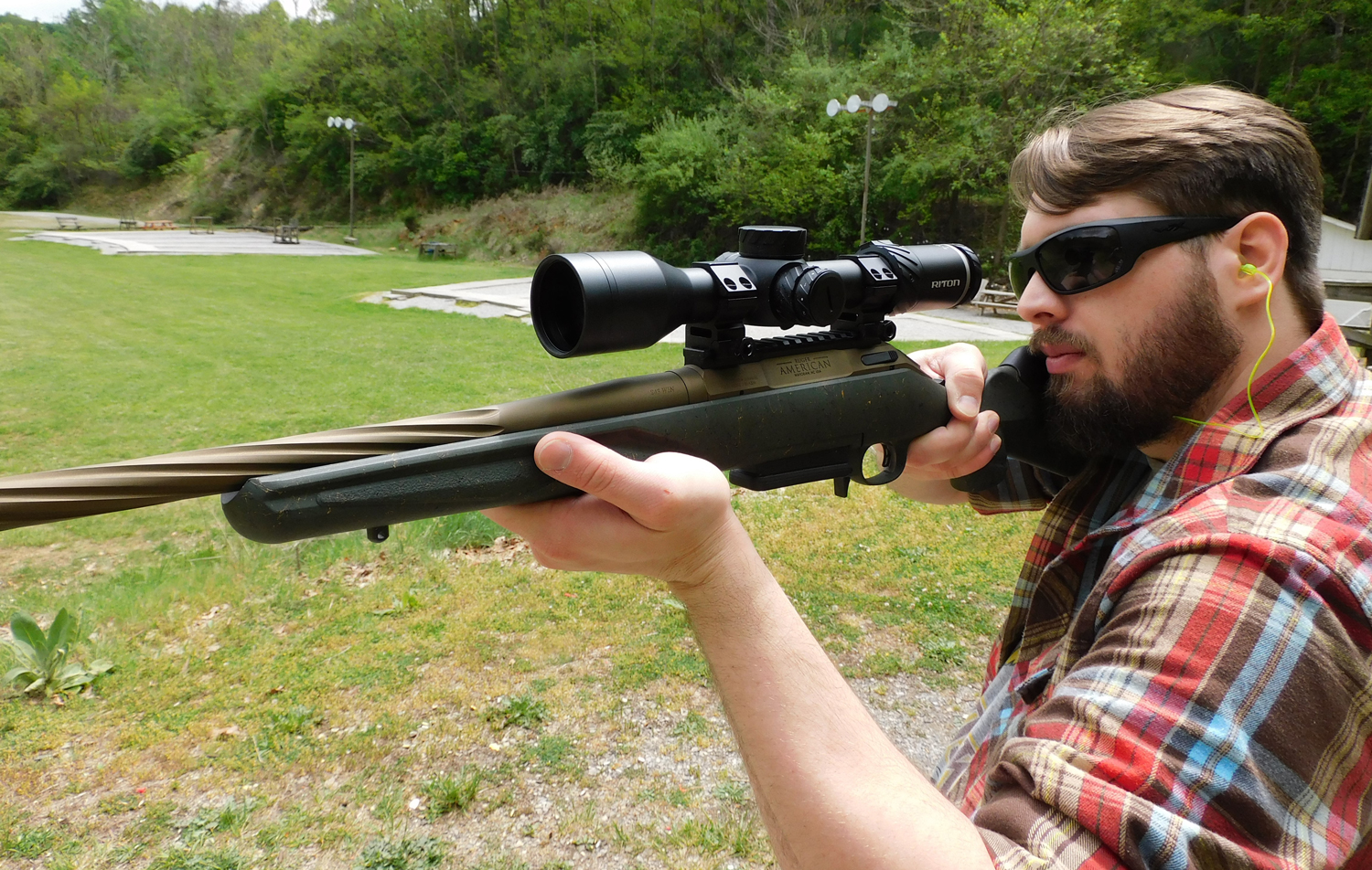 The author firing the Ruger American Gen II Predator at a shooting range