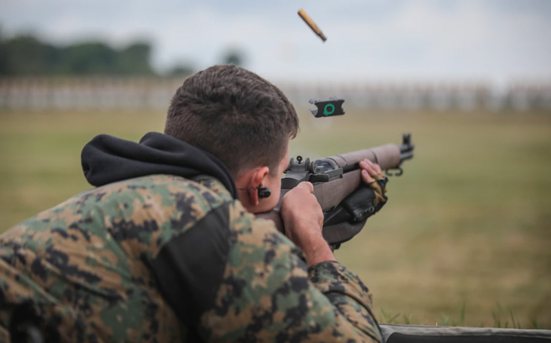 A United States marine firing an M1 garand rifle