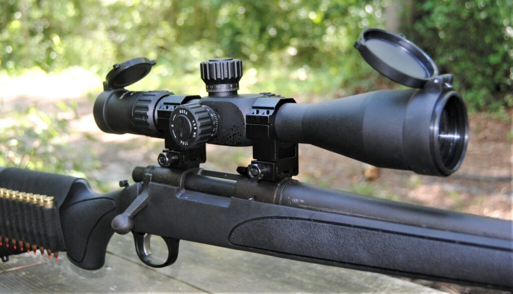 A scope mounted to a rifle with the objective lens close