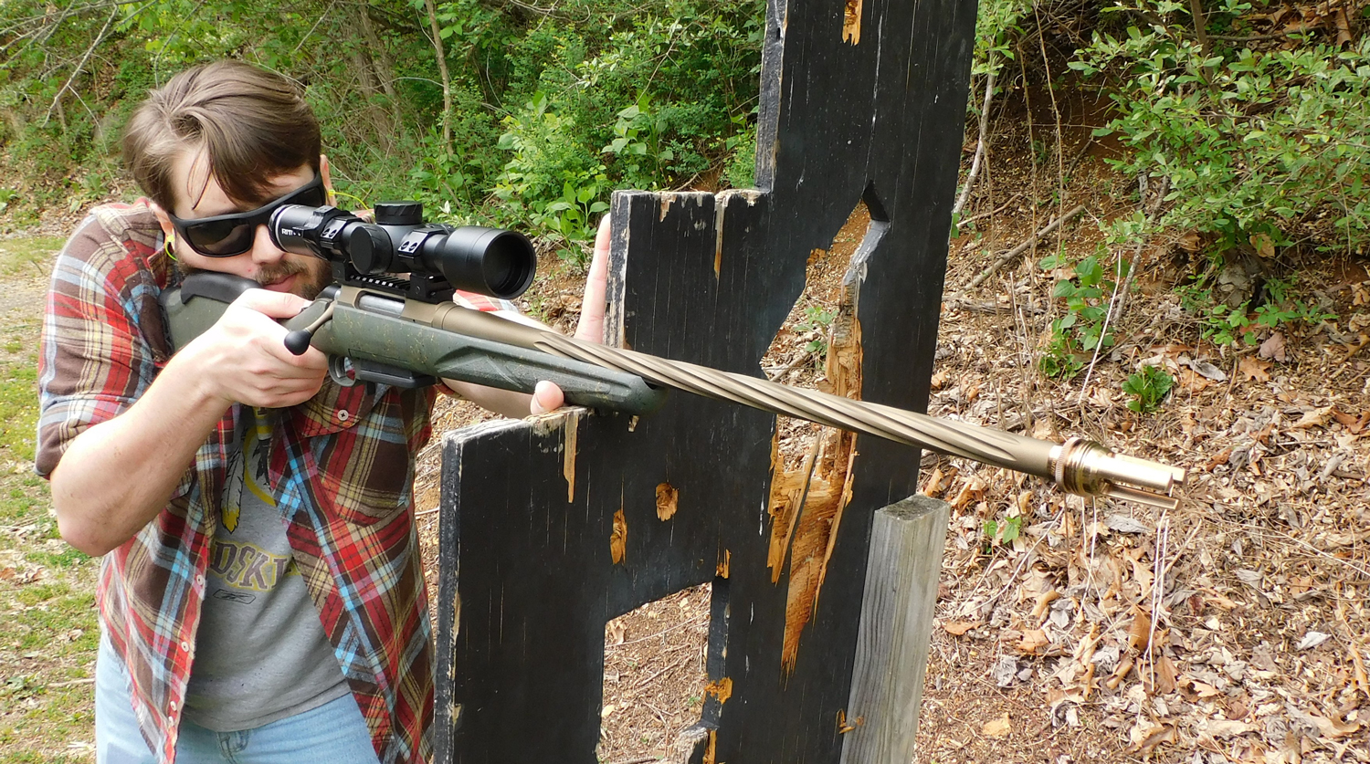 The author firing the Ruger American Gen II Predator rifle from behind a barrier