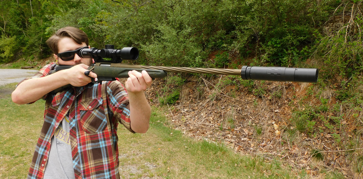 The author shooting the Ruger American rifle with a suppressor