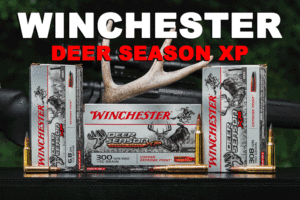 Winchester Deer Season XP on a shooting bench with deer antlers