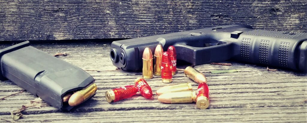 Ammunition along with a pistol on a shooting bench
