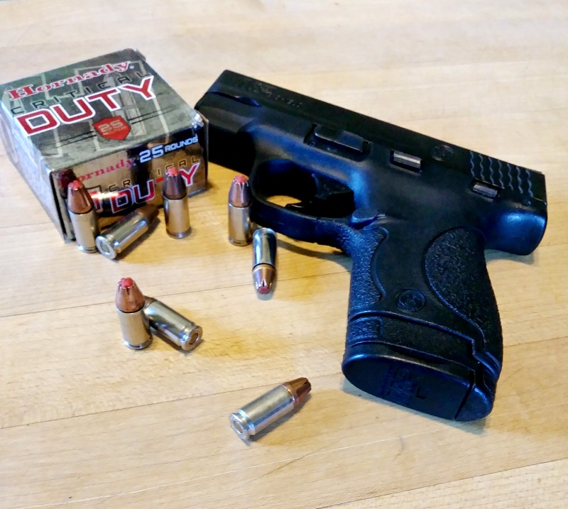 A 380 pistol with ammo Demonstrating a concealed carry gun carried in the small of your back.