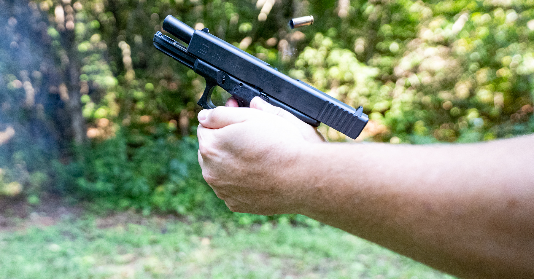 A pistol's recoil demonstrated at a shooting range