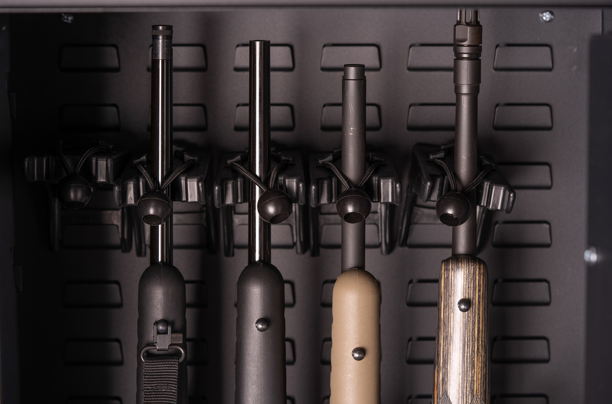 rifles in a safe lined up showing benefits of a gun trust