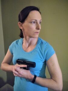 The author demonstrating center axis relock with a pistol