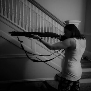 the author with a shotgun in her home