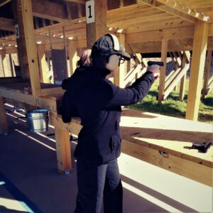 demonstrating center axis relock stance on the firing line The author at the shooting range shooting with the center axis relock stance