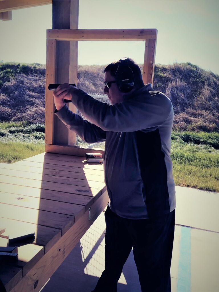 A left-handed shooter using center axis relock at the shooting range.