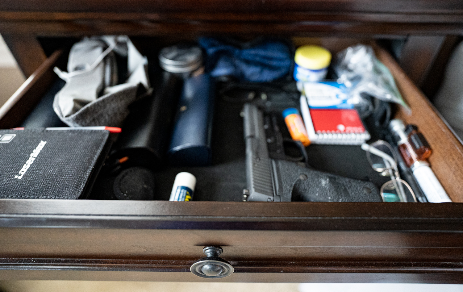 A pistol in a nightstand drawer