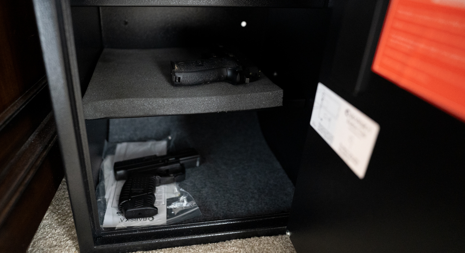 A pair of pistols stored in a safe for home defense