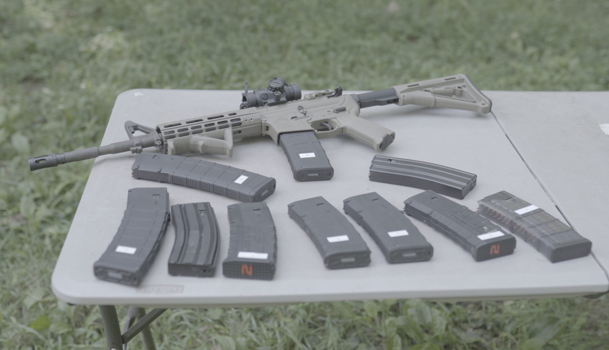 rifle magazines on a table with an ar-15