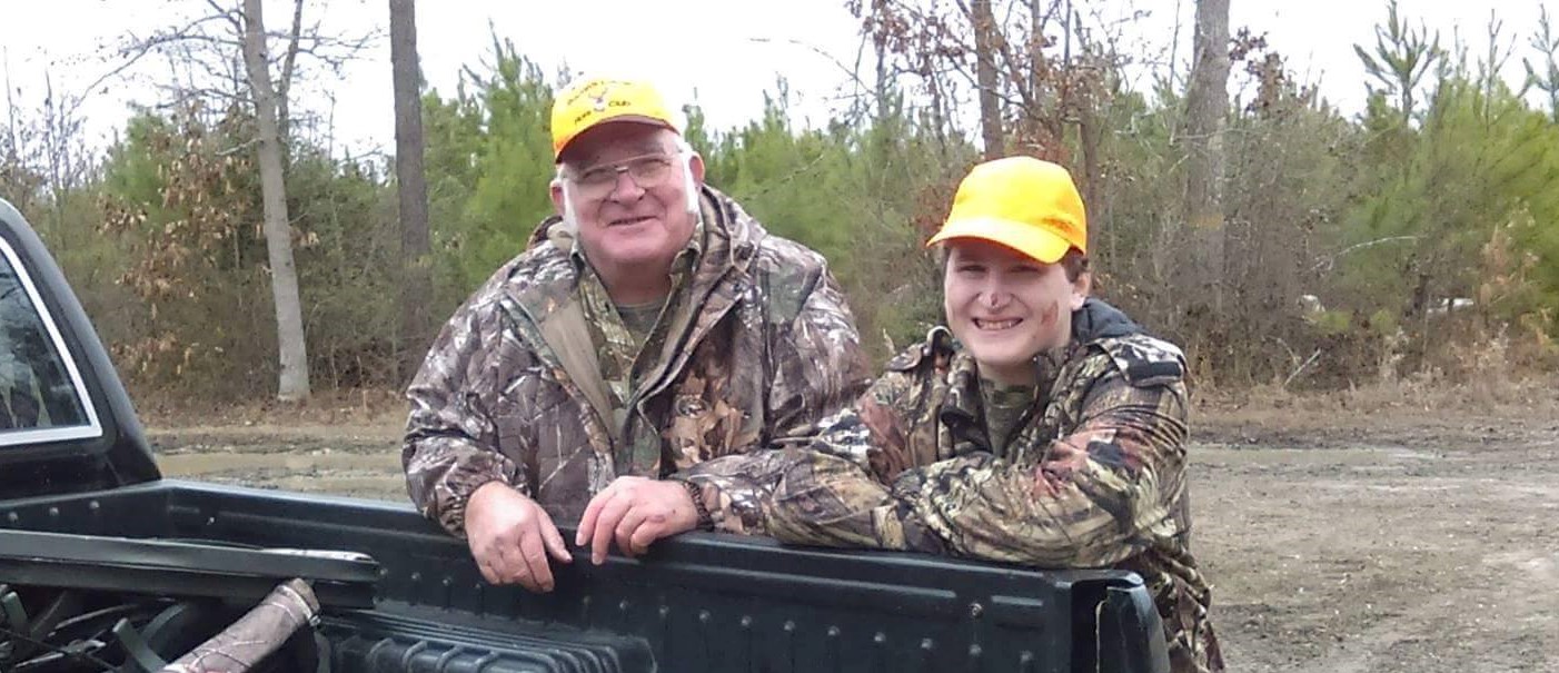 The author's father and her son deer hunting