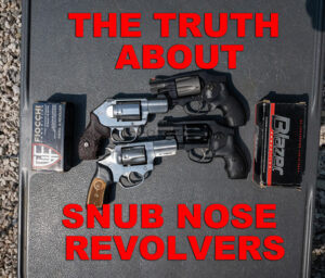 snub nose revolvers and ammo on a shooting bench